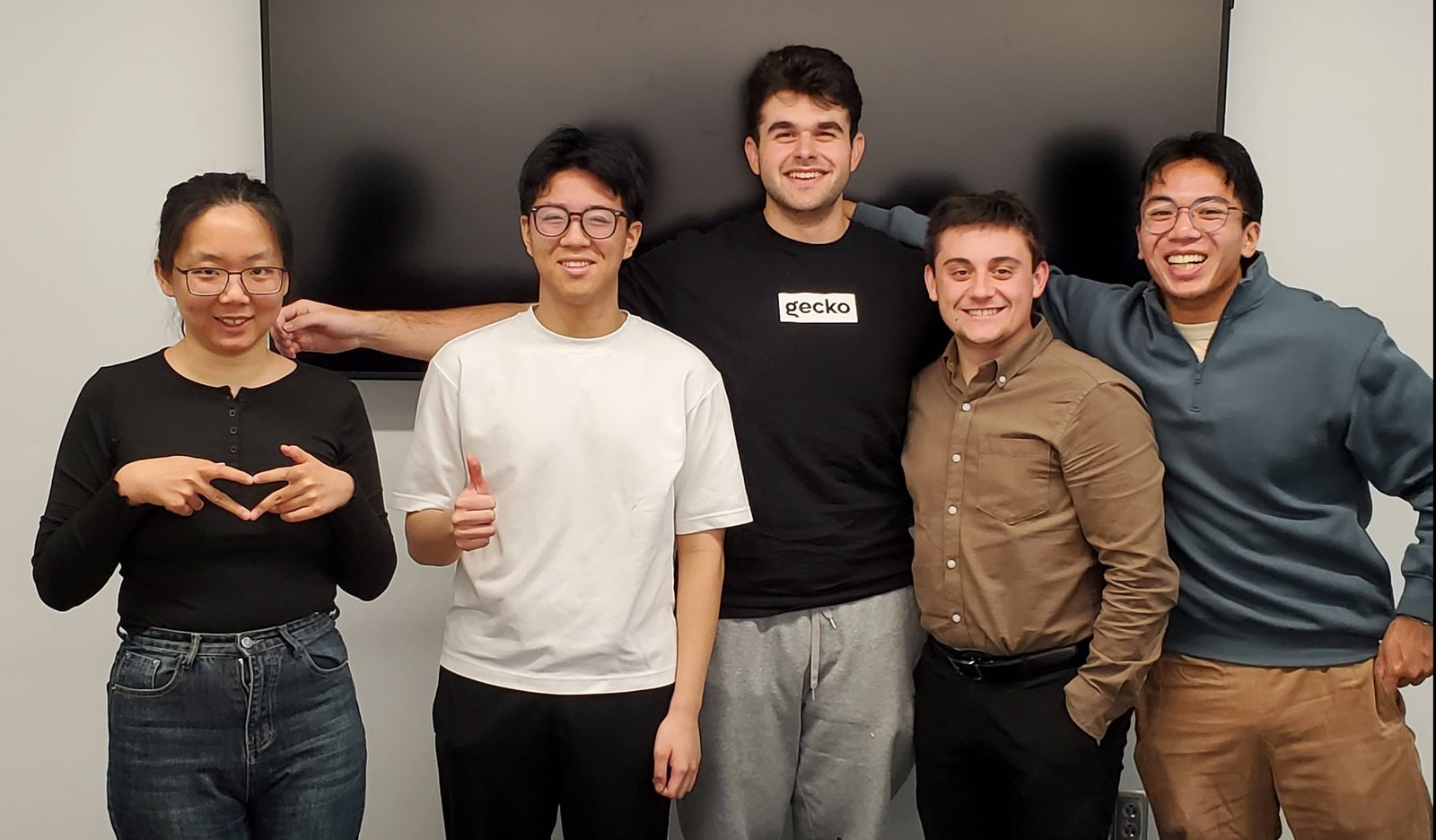 The five-person CMSC435 team standing together in a conference room after wrapping up the project.